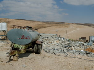 Rubble and concrete debris from the demolished home of Yaser Abu Sabha lie scattered beside a water tank trailer in Masafer Yatta, in the Israeli-occupied West Bank, on Sept. 24, 2026.