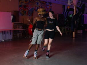 Chrishana Simon and Diana Ledet skate around the New Orleans Free Store, talking and laughing.