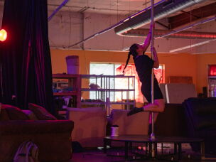 Diana Ledet, who volunteers at the New Orleans Free Store, plays around on a pole.