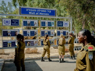 Israeli soldiers visit a memorial commemorating security personnel who died defending those who came under attack at the Nova festival site.
