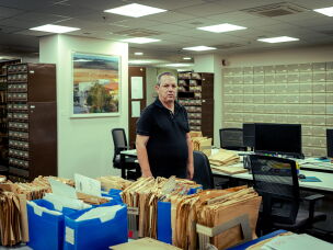 Amos Harel, military and defense analyst for the Israeli daily Haaretz, is pictured inside the newspaper's archival library in Tel Aviv. Harel has extensively reported on Israeli defense strategy, military operations, and Middle East security for decades.