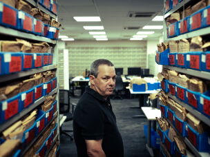 Amos Harel, defense analyst for the Israeli daily Haaretz, stands inside the newspaper's archival library in Tel Aviv.