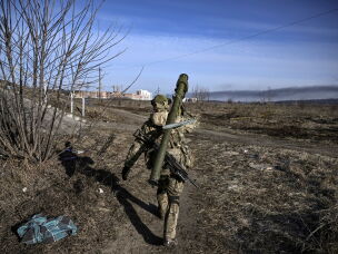A Ukrainian serviceman walks toward the front line in Irpin on March 12, 2022.