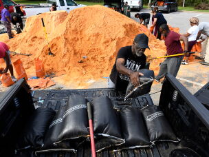 Residents pick up sandbags for storm preparation at the James Seals Jr. Parks & Recreation Center ahead of Hurricane Isaias' expected landfall along the Gulf Coast, Thursday, Oct. 8, 2026, in Mobile, Ala.