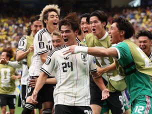 Kaishu Sano (#24) of Japan celebrates with teammates after scoring the team's first goal during Japan's match against Brazil on June 29 in Houston.
