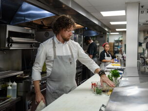 Chef Brian Landry assembles the ingredients to prepare grilled pompano with broken romesco sauce. He says the dish showcases the various cultural influences that define creole cuisine.<br>
