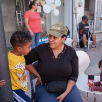 Yasmelin Velazquez, 35, from Venezuela sits with her sons Jordan Velazquez, 3, (L) and Jeremias Velazquez, 2, (R) while selling souvenirs in Ciudad Juárez, Chihuahua state, Mexico on Saturday, June 29, 2024. Velazquez is part of a growing number of migrants staying in Juárez and working while trying to get an appointment via the CBP One application.
