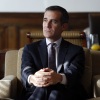 This photo shows Eric Garcetti, then the mayor of Los Angeles, during an interview in his office at City Hall in Los Angeles on Jan. 13, 2015. He's wearing a dark blue suit and a dark patterned tie and is seated in an armchair with his legs crossed and his hands over his top knee.