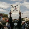 A protester holds a placard during a demonstration against repeated water and electricity outages in Madagascar.