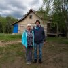 Stuart and Jackie Pacheo stand where the entryway to their home of 30 years was before the floods from Hurricane Helene washed it away. The circles of the tops of foundation pillars in the dirt behind them are all that remains of the Pacheo home.
