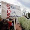 A person holds a sign reading "Save Our Social Security" during a rally in support of fair taxation near the U.S. Capitol on April 10, 2025.