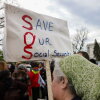 A person holds a sign reading "Save Our Social Security" during a rally in support of fair taxation near the U.S. Capitol on April 10, 2025.
