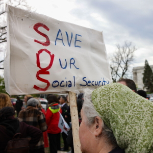 A person holds a sign reading "Save Our Social Security" during a rally in support of fair taxation near the U.S. Capitol on April 10, 2025.
