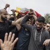 Mourners carry the body of 14-year-old Palestinian Amir Rabee, a U.S. citizen, during his funeral in the village of Turmus Ayya, in the Israeli-occupied West Bank, on Monday.