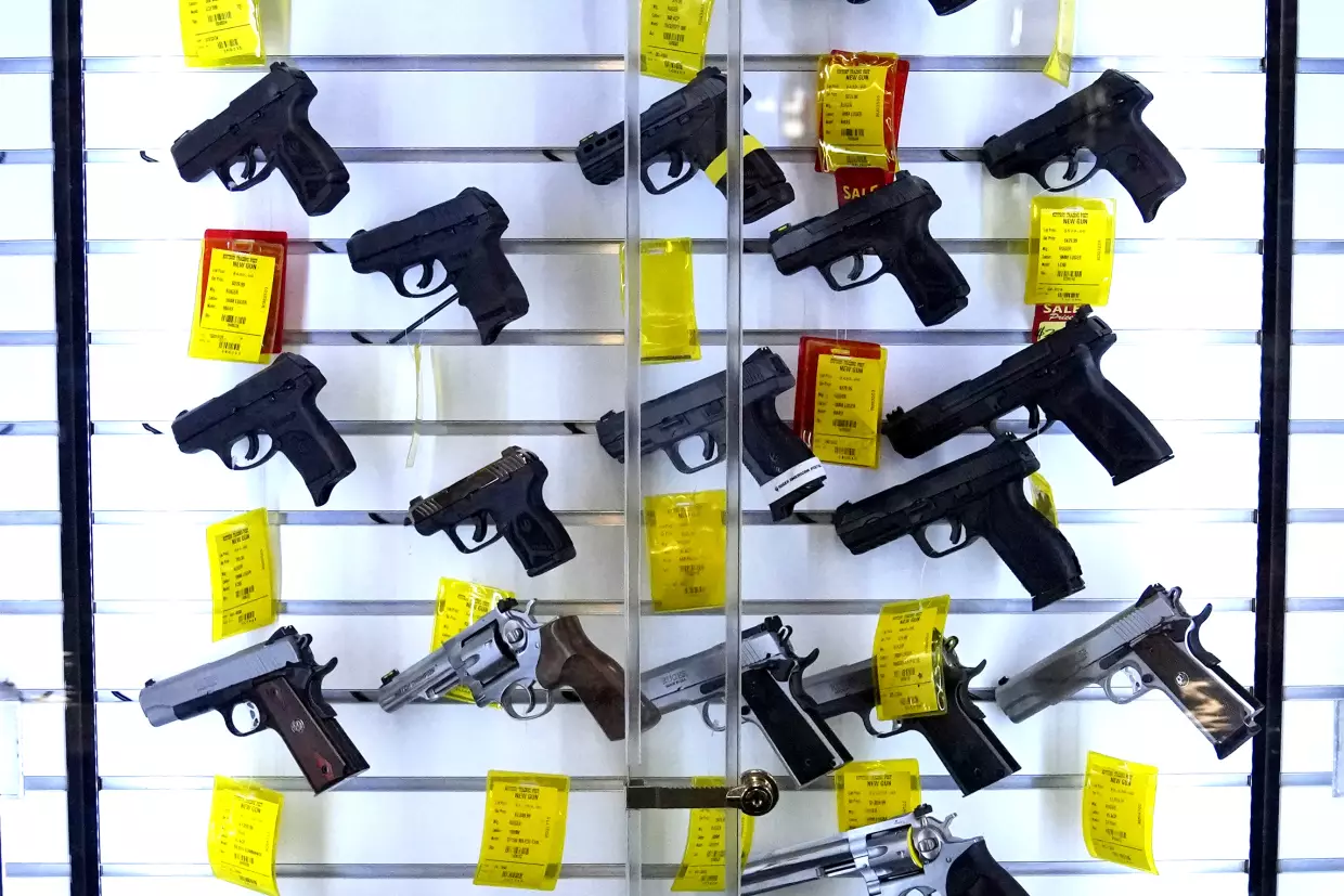 A study estimates that 32 million children live in homes with firearms, and a significant portion of those guns are not stored safely. Here, handguns are displayed at Kittery Trading Post, in Kittery, Maine.