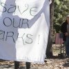 People protest the mass layoffs of federal employees at Yosemite National Park on March 1, 2025. Many workers at the U.S. Department of Interior and other agencies are being reinstated following court orders.