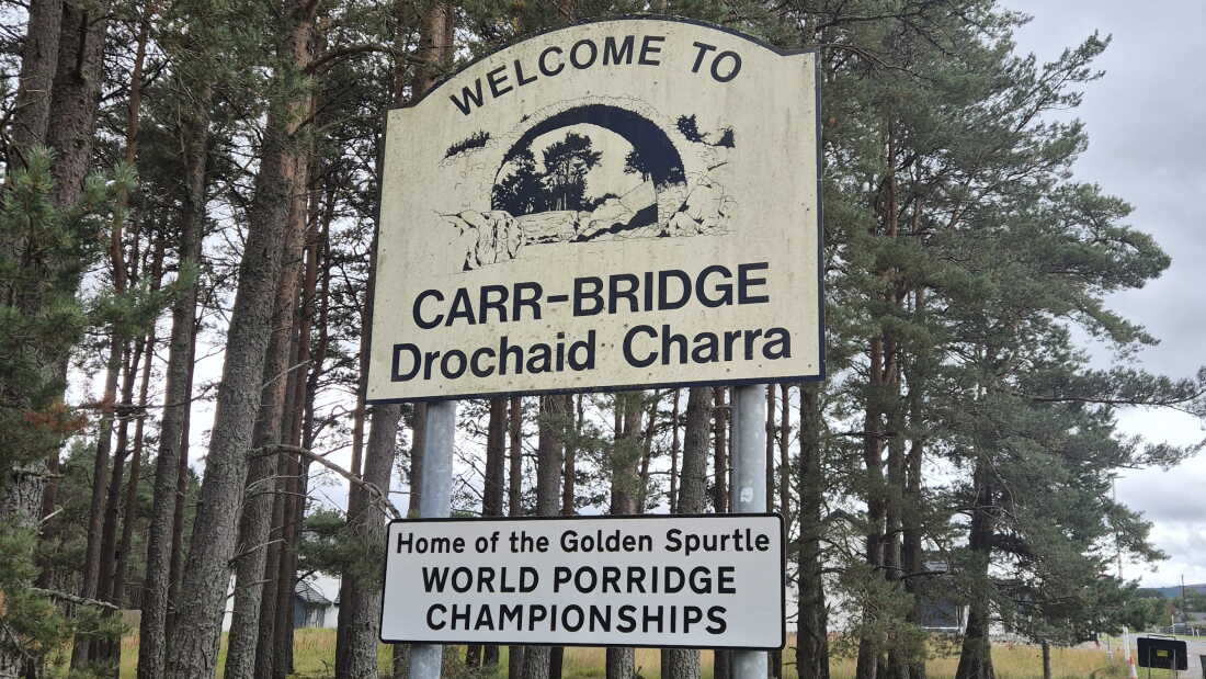 A sign reads Welcome to Carr-Bridge, is the home of the World Porridge Championships.