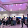 People stand in line at check-in counters at El Paso International Airport, Wednesday. The Federal Aviation Administration closed the airspace around the area for a few hours.