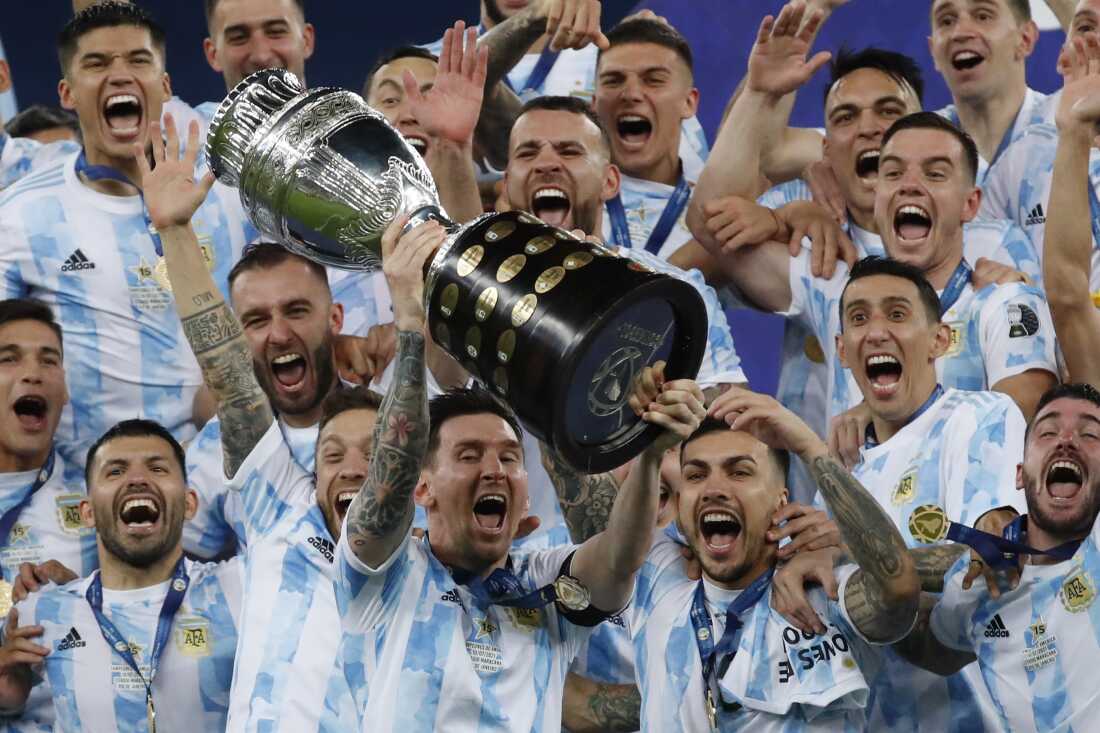Argentina's Lionel Messi celebrates with the trophy after beating Brazil 1-0 in the Copa America final soccer match at Maracana stadium in Rio de Janeiro, Brazil, Saturday, July 10, 2021. Messi and Argentina will try to win their third straight major title when they defend their Copa America championship while Brazil hopes 17-year-old Endrick will combine with Vinícius Júnior and Rodrygo for success.