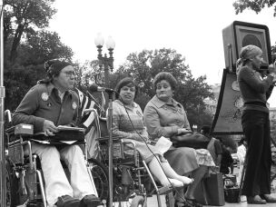 Activists Kitty Cone, Judy Heumann, Eunice K. Fiorito and sign language interpreter Jadine Murello at a 1977 gathering of disabled Americans in Washington D.C., demanding the enforcement of Section 504 of the Rehabilitation Act. After a 28-day-long sit-in at a federal building in San Francisco, they won the regulations that helped enforce integration of people with disabilities.
