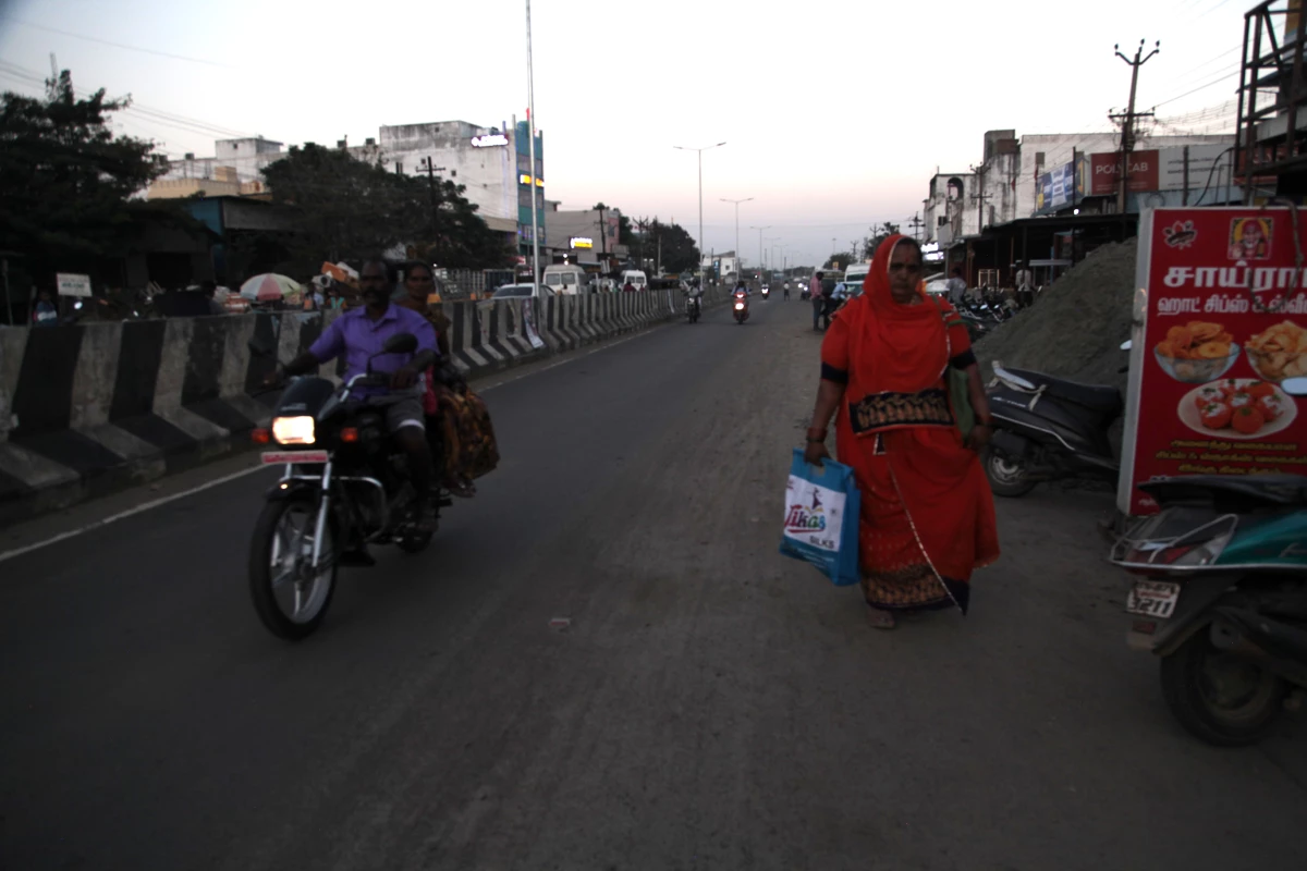 A woman walks at dusk in the district of Sriperumbudur in the southern Indian state of Tamil Naidu.