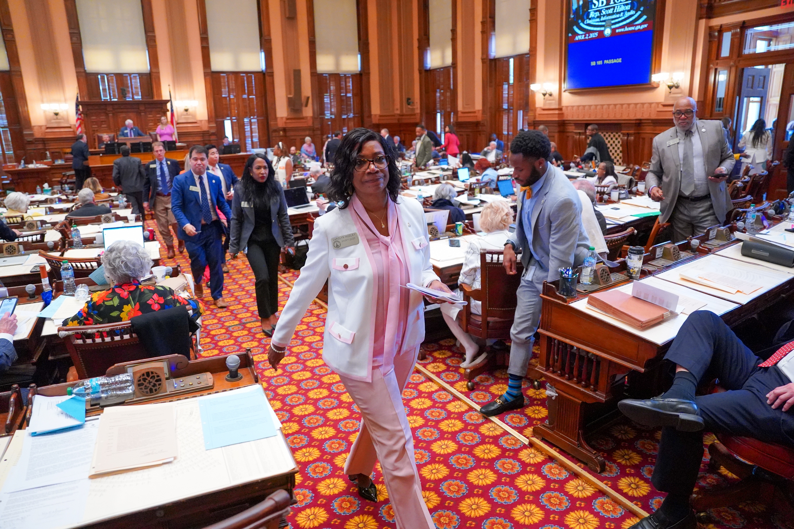 Democratic lawmakers, led by Minority Leader Carolyn Hugley, walk out of the Georgia House of Representatives last month, skipping a vote on a bill to ban gender-affirming care for inmates in state prisons.