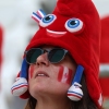 A Canada fan dons an Olympic mascot Phryge hat before the women's quarter-final football match between Canada and Germany during the Paris Olympics.