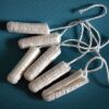 A pile of tampons against a blue background.