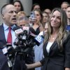 Karen Read, right, smiles as defense attorney David Yannetti, front left, speaks to reporters in front of the courthouse.