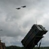 Ukrainian Air Force F-16 fighter jets fly over a Patriot air and missile defense system in an undisclosed location in Ukraine, on Aug. 4, 2024.