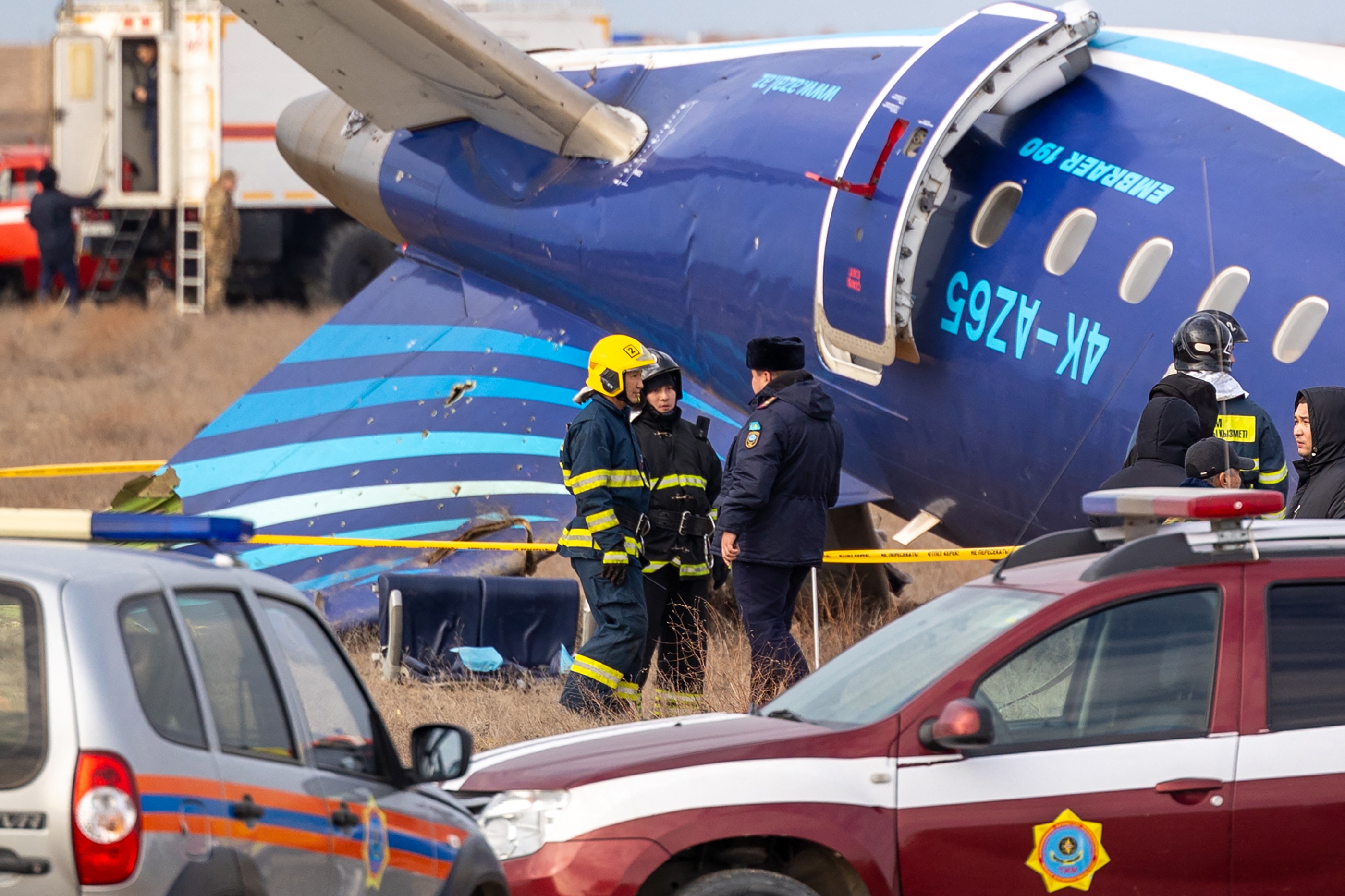 Emergency specialists work at the crash site of an Azerbaijan Airlines passenger jet near the western Kazakh city of Aktau.