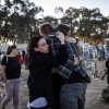People embrace next to memorials of victims of the Oct. 7, 2023, attacks at the Nova Festival grounds in Reim, in southern Israel, on the second anniversary of the Hamas-led attacks on Tuesday.