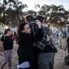 People embrace next to memorials of victims of the Oct. 7, 2023, attacks at the Nova Festival grounds in Reim, in southern Israel, on the second anniversary of the Hamas-led attacks on Tuesday.