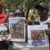 Relatives of Kenyan citizens recruited by the Russian military in Ukraine pose with photographs of their family members during a demonstration demanding immediate government action to repatriate their relatives in Nairobi on February 19, 2026.