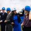 Chelsea Andrews (white hat), president and executive director of Montgomery County's Housing Opportunities Commission, adjusts Maryland State Delegate Lorig Charkoudian's hardhat during a groundbreaking ceremony for the Hillandale Gateway housing development in Silver Spring, Md. The HOC says it owns more than 9,400 apartment, townhome and single-family home rental properties and provides subsidized housing for more than 9,300 households.