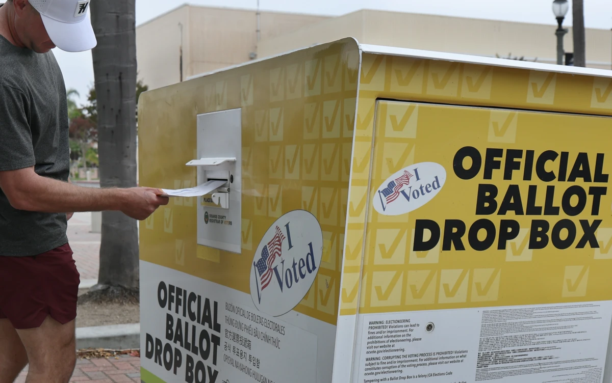 Garrett Morgan, of Huntington Beach, Calif., puts his statewide special election ballot in an official ballot drop box in Huntington Beach on Oct. 25.