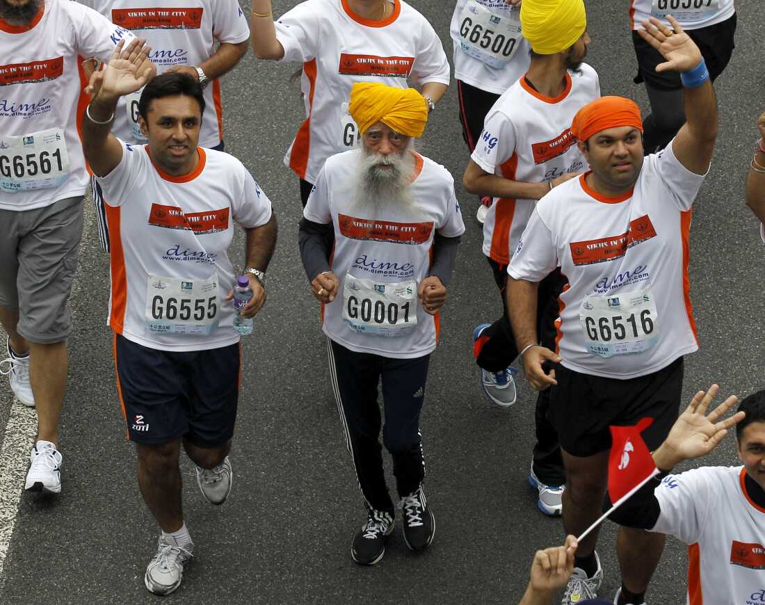 Centenarian marathon runner Fauja Singh, then aged 101, center, runs in a 10-kilometer race, held as part of the annual Hong Kong Marathon, in Hong Kong in 2013.