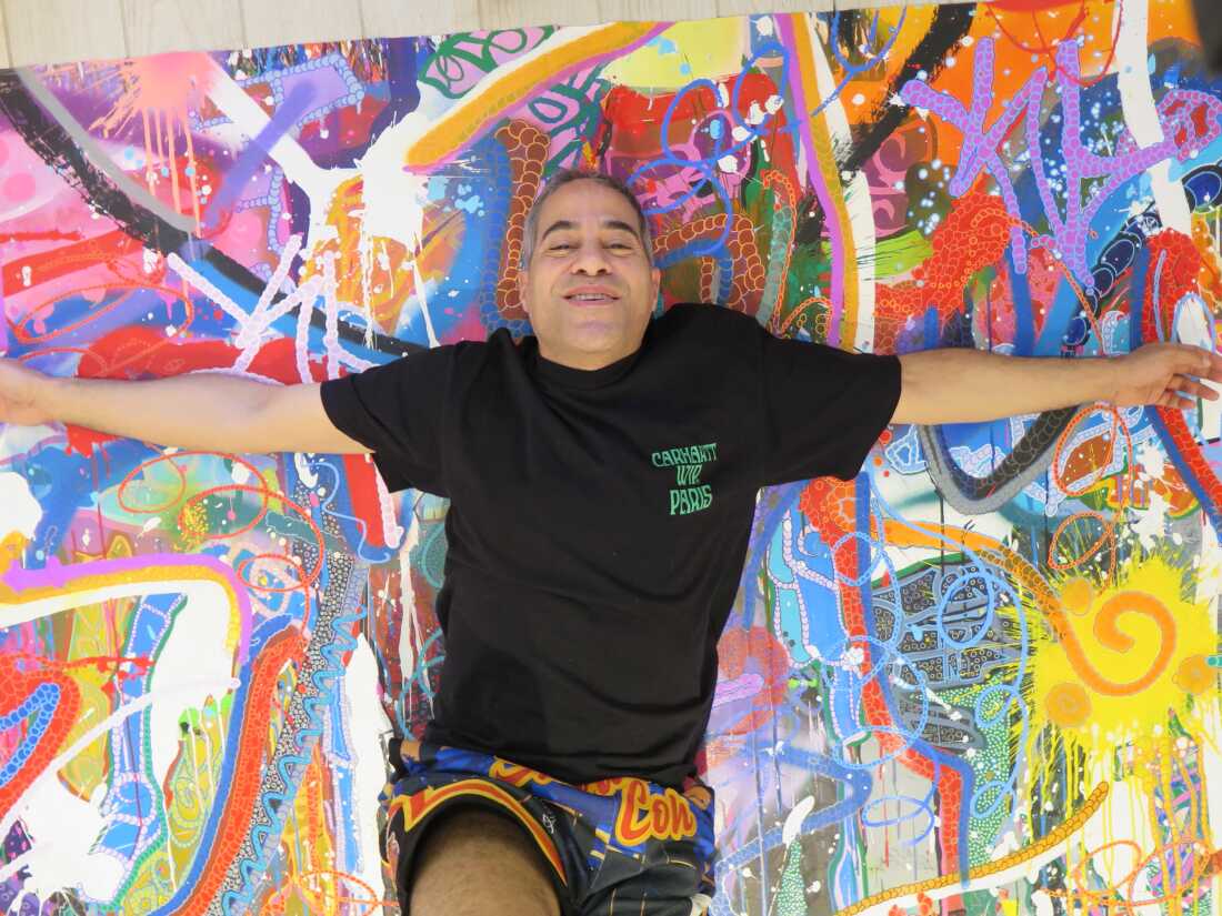 JonOne with one of the paintings featured in his sol show at Miami's Museum of Graffiti.