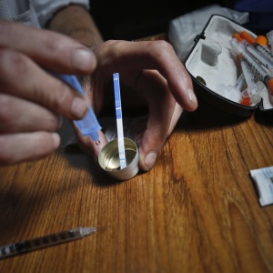 A drug user uses a test strip on Aug. 22, 2018, in New York, to see if fentanyl has been added to heroin, which could increase the risk of overdose.