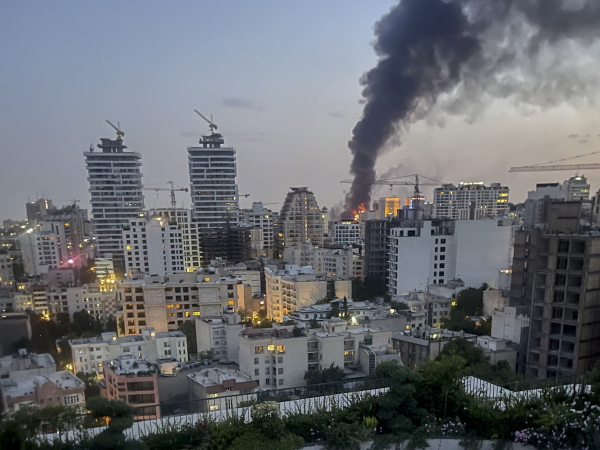 Smoke rises from the rubble of an Iranian state media building in Tehran after an Israeli airstrike on June 16, 2025. The strike, which Israel confirmed targeted "terror-linked propaganda infrastructure," marks a further escalation in regional tensions.