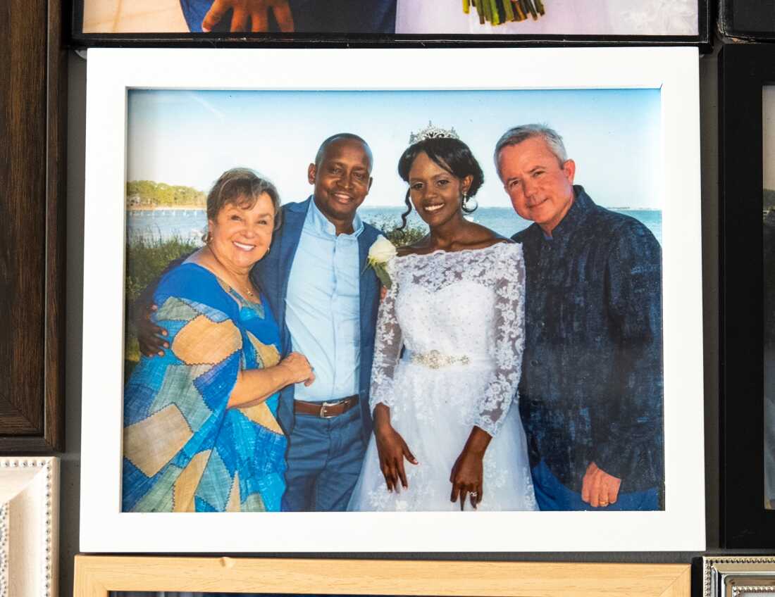 James Kassaga Arinaitwe and his wife, Daphine Namara, on their wedding day in St. Teresa, Fla., in October 2019. They're flanked by the U.S. couple who took him in when he began college: Russell and Cheri Rainey.