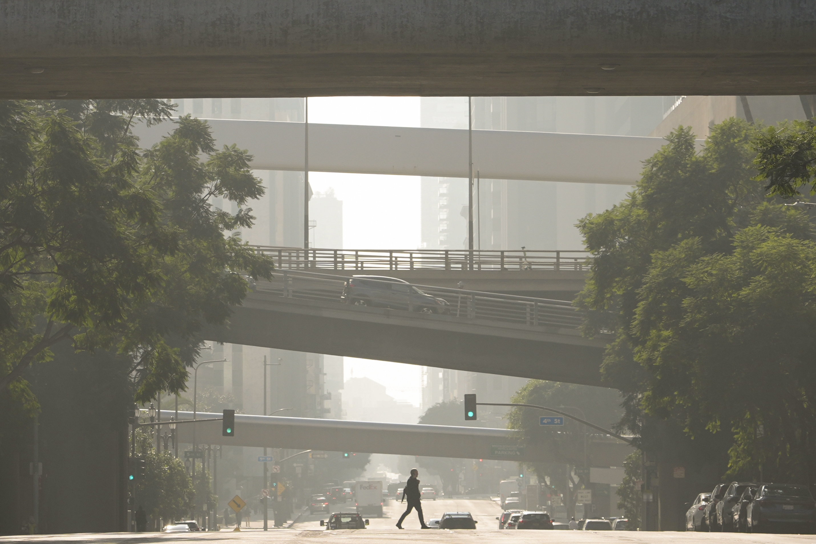 A person crosses a street as smog fills the air Wednesday, Dec. 4, 2024, in Los Angeles. (AP)