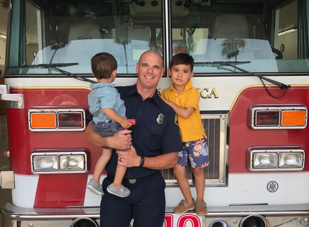 <em>Old photo of fire Capt. Shane Lawlor and his two sons at a Santa Monica Fire Station. Lawlor has been a firefighter for 17 years. He was dispatched last week to the Pacific Palisades and is still fighting the fires there.</em>