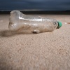 A plastic bottle and the remains of a child's spade on the beach in Prestatyn, U.K..