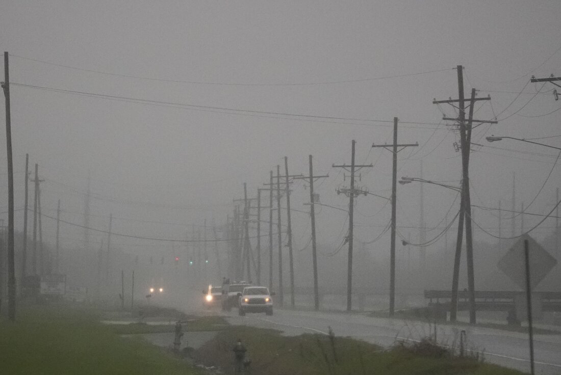 Cars drive through rain bands along Peter Rd., just outside New Orleans, ahead of Tropical Storm Francine, in Harvey, La., on Tuesday.