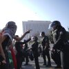 Protesters confront Los Angeles Police Department personnel in riot gear in downtown Los Angeles on Monday, June 9, 2025. (AP Photo/Eric Thayer)
