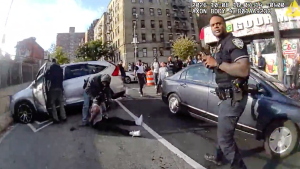 In this image taken from police-worn body camera video released the New York City Police Department (NYPD), law enforcement personnel tend to a Oscar Belgal, 28, a Dominican man who was shot by Federal immigration officers, Thursday, Oct. 8, 2026, in New York, as he drove his car with a 5-year-old boy inside. 
