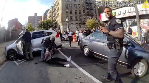 In this image taken from police-worn body camera video released the New York City Police Department (NYPD), law enforcement personnel tend to a Oscar Belgal, 28, a Dominican man who was shot by Federal immigration officers, Thursday, Oct. 8, 2026, in New York, as he drove his car with a 5-year-old boy inside. 