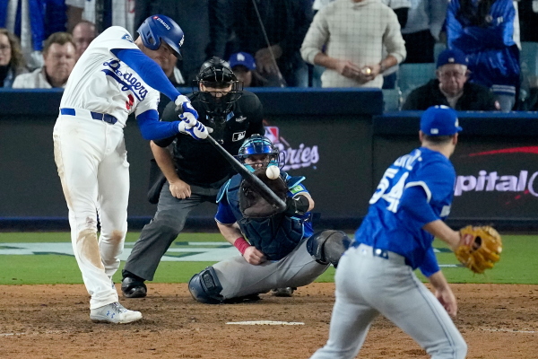 Los Angeles Dodgers' Freddie Freeman connects for a grand slam home run off Toronto Blue Jays' pitcher Brendon Little (54) during the 18th inning in Game 3 of baseball's World Series, Monday, Oct. 27, 2025, in Los Angeles.