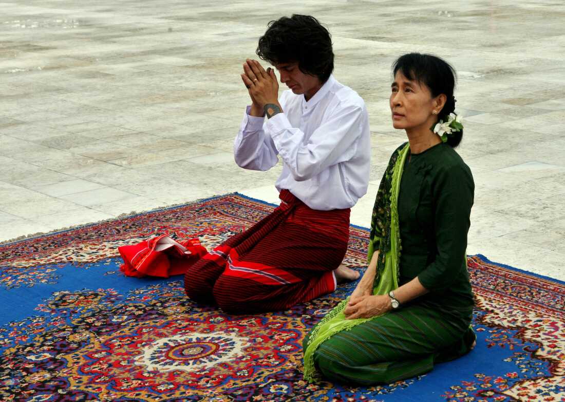 Aung San Suu Kyi, right, and her youngest son Kim Aris pay respect to the late Gen. Aung San, father of Suu Kyi, at the Martyr's Mausoleum in Yangon, Myanmar, Tuesday, July 12, 2011.